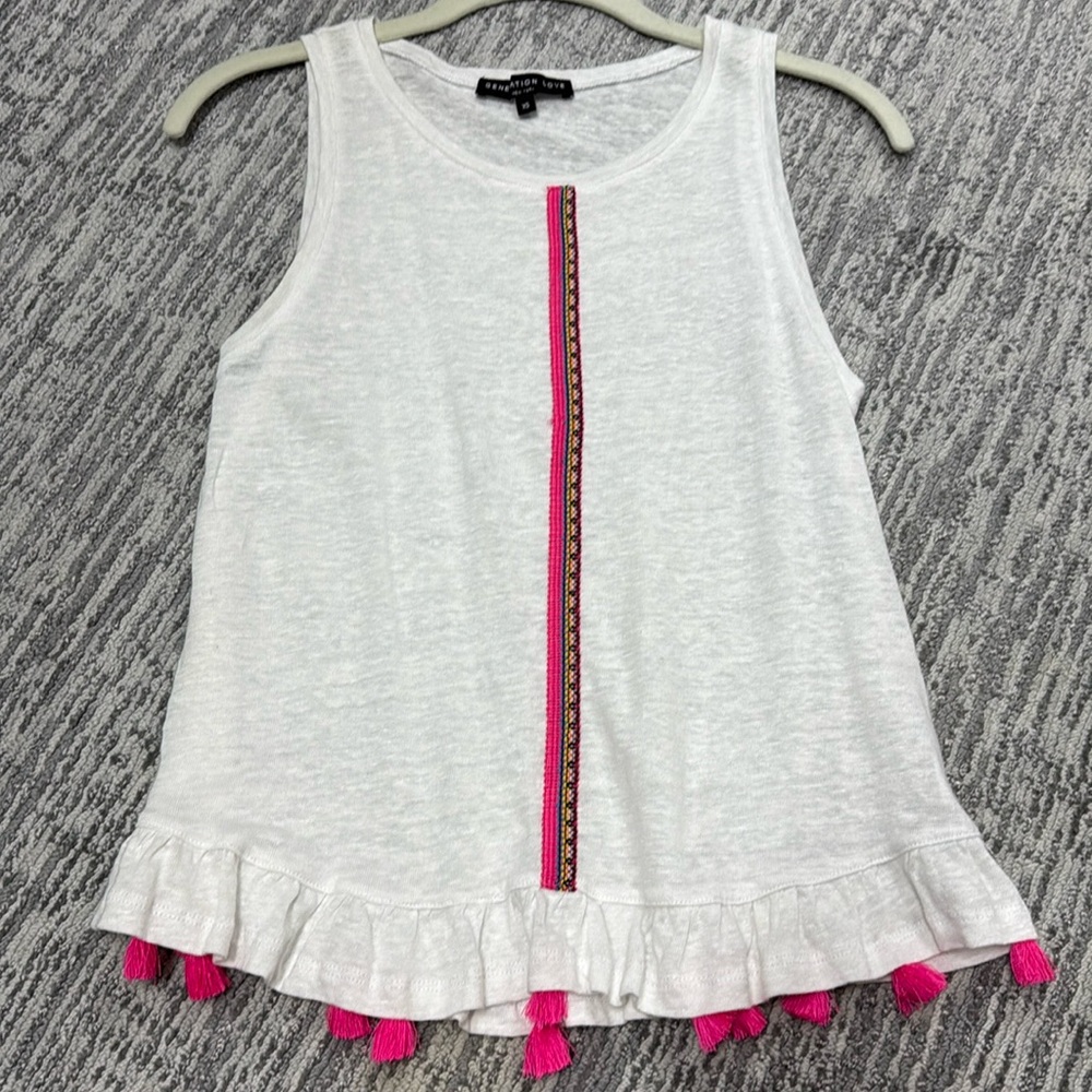Linen sleeveless top with embroidery and tassels.